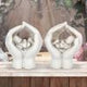 Set of Two Small Shelter 7cm Baby in Cradled Hands Figurines